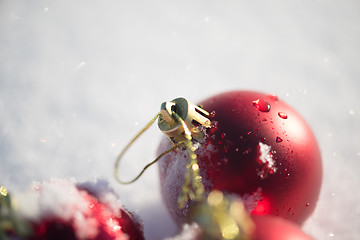 Image showing red christmas ball in fresh snow