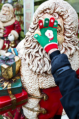 Image showing Santa Claus statue with a hand on the face