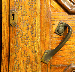 Image showing the travedona monate rusty brass brown knocker in a  door  