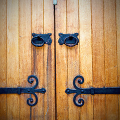 Image showing handle in london antique brown door  rusty  brass nail and light