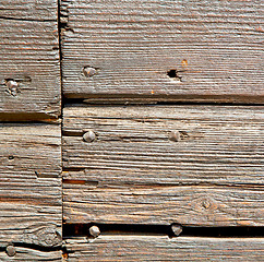 Image showing abstract texture of a brown antique wooden old door in italy   e