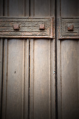 Image showing in london antique brown door  rusty  brass nail and light