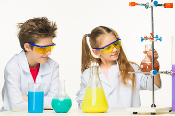 Image showing Two cute children at chemistry lesson making experiments