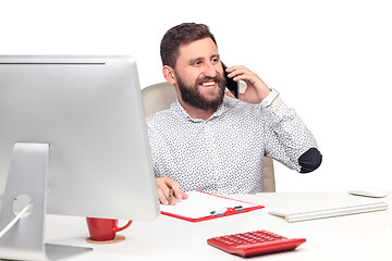 Image showing Portrait of businessman talking on mobile phone in office