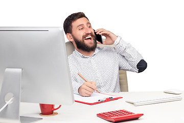 Image showing Portrait of businessman talking on mobile phone in office