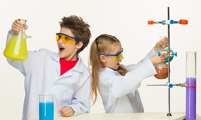 Image showing Two cute children at chemistry lesson making experiments