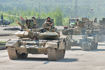 Image showing Modernized tank T-72 and convoy in motion. Russia