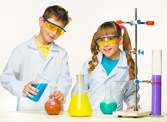 Image showing Two cute children at chemistry lesson making experiments