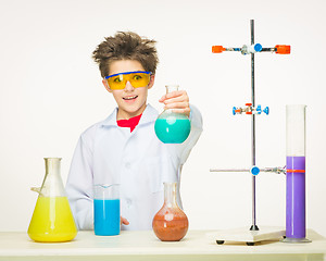 Image showing Little boy as chemist doing experiment with chemical fluid 