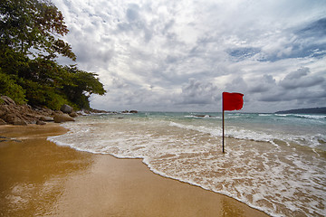 Image showing  Secluded beach with a red flag