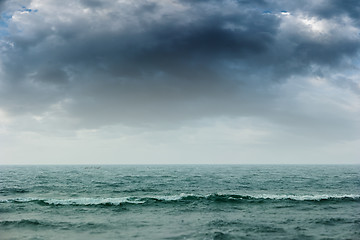 Image showing Stormy intense dark clouds over the ocean