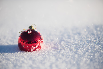 Image showing red christmas ball in fresh snow