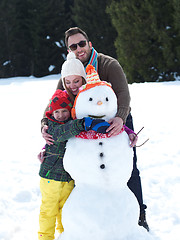 Image showing happy family making snowman