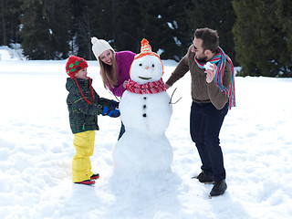 Image showing happy family making snowman