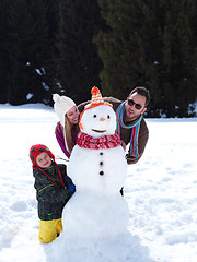 Image showing happy family making snowman