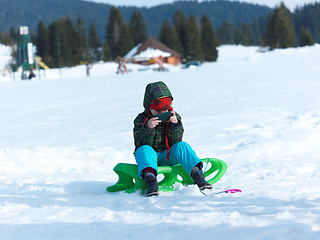 Image showing young boy have fun on winter vacatioin and play games on phone