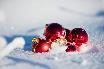 Image showing red christmas ball in fresh snow