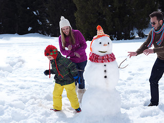 Image showing happy family making snowman