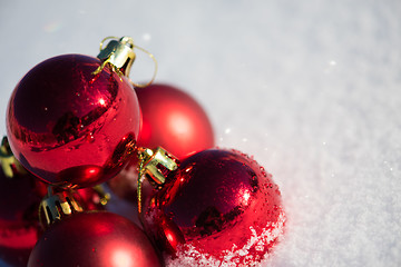 Image showing red christmas ball in fresh snow