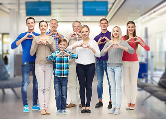 Image showing group of smiling people showing heart hand sign