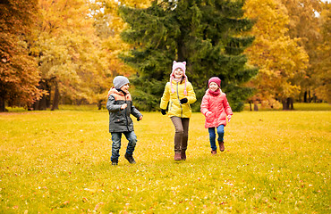 Image showing group of happy little kids running outdoors