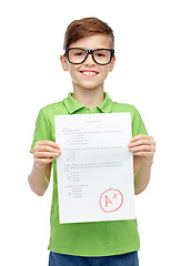 Image showing happy boy in eyeglasses holding school test result