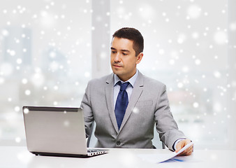 Image showing businessman with laptop and papers