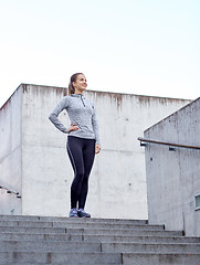 Image showing smiling sportive woman on stairs at city