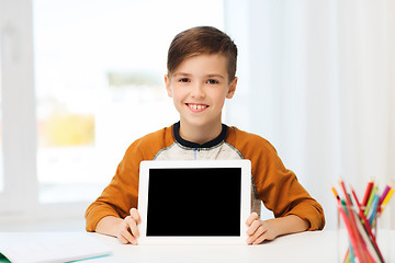 Image showing smiling boy showing tablet pc blank screen at home