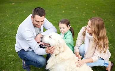 Image showing happy family with labrador retriever dog in park