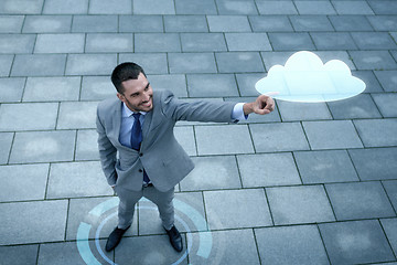 Image showing smiling businessman with cloud projection outdoors