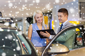 Image showing happy woman with car dealer in auto show or salon