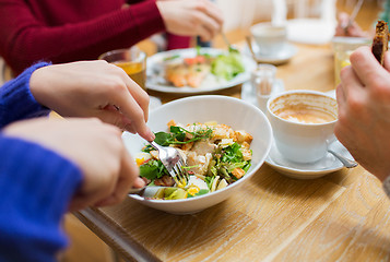 Image showing close up friends having dinner at restaurant