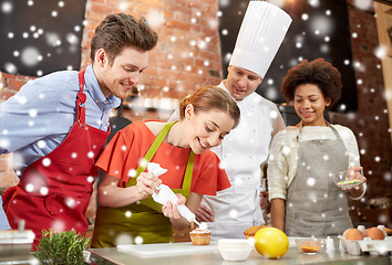 Image showing happy friends and chef cook baking in kitchen