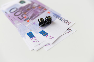 Image showing close up of black dice and euro cash money