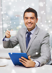 Image showing smiling businessman with tablet pc and coffee cup