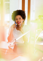 Image showing businesswoman calling on smartphone at office