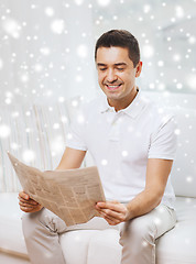 Image showing happy man reading newspaper at home