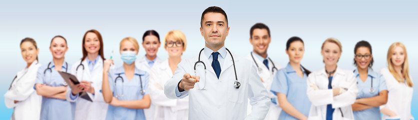 Image showing group of doctors with clipboard pointing at you