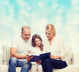 Image showing happy family with book at home