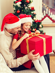 Image showing smiling father and daughter opening gift box