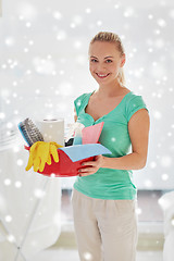 Image showing happy woman holding cleaning stuff at home