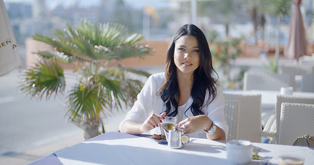 Image showing Girl Sitting At Cafe With Cup Of Tea