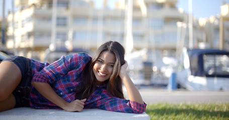 Image showing Girl Lying On A Park Bench