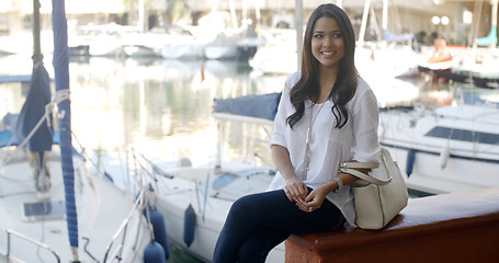 Image showing Woman Relaxing On Bench In Yacht Port