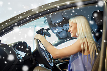 Image showing happy woman inside car in auto show or salon