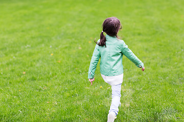 Image showing little girl walking along summer green meadow