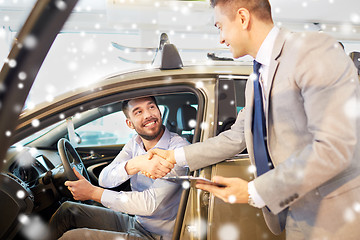 Image showing happy man with car dealer in auto show or salon