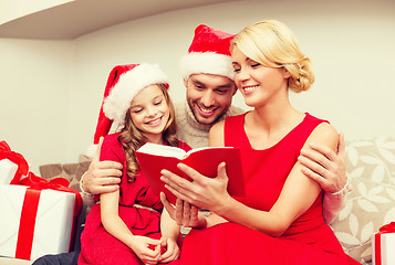 Image showing smiling family reading book