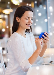 Image showing smiling woman with smartphone and coffee at cafe